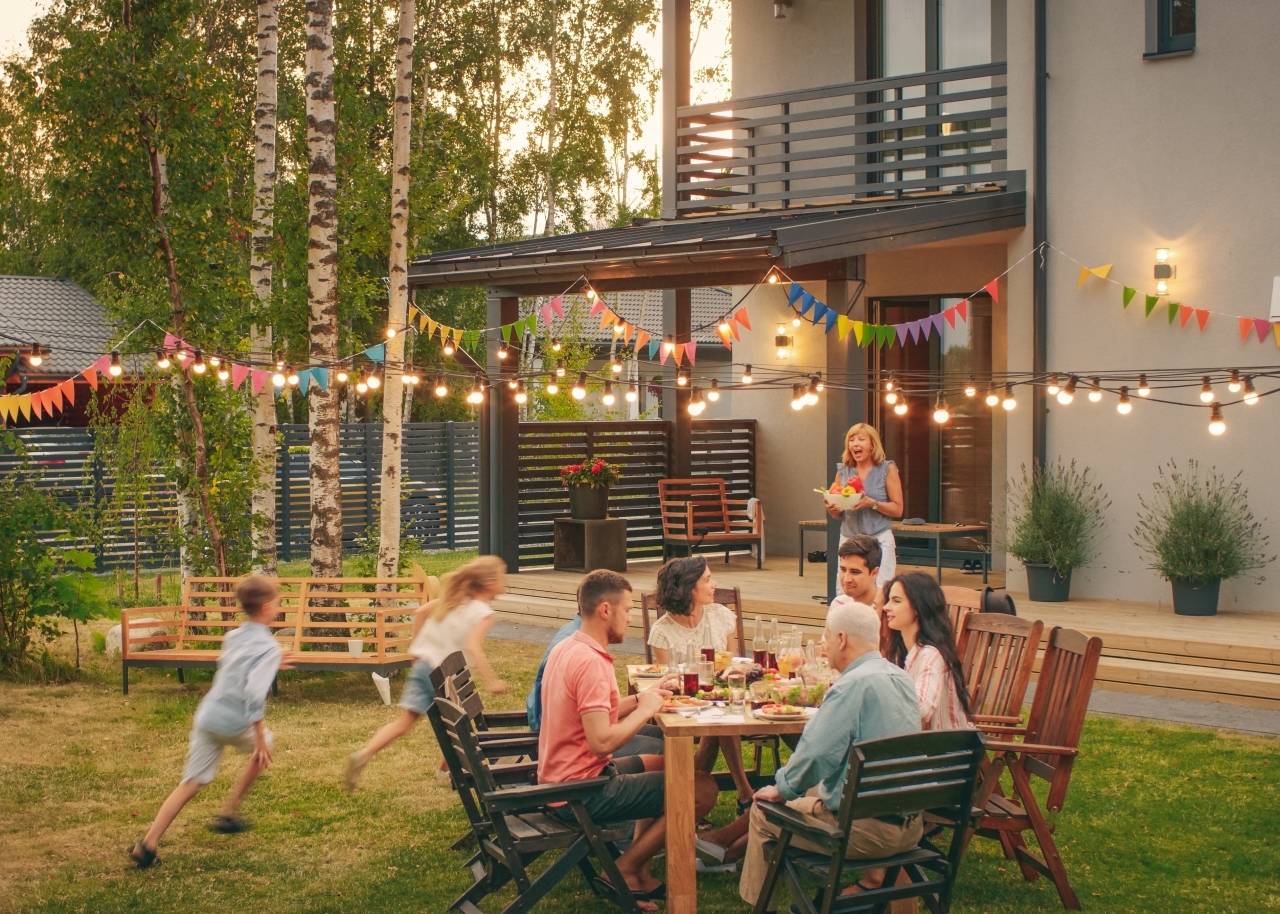 Big Family Garden Party Celebration, Gathered Together at the Table Family, Friends and Children.